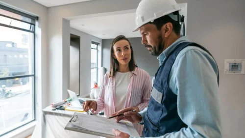Homeowners asking questions to a roofing contractor before a project starts