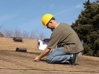 Professional inspecting a roof to determine maintenance needs