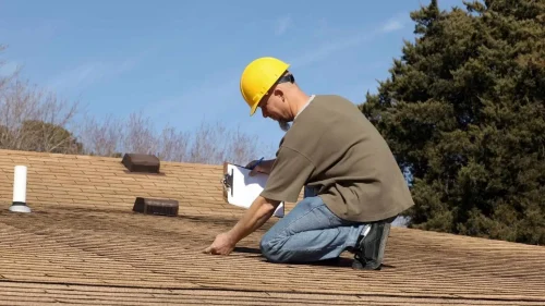 Professional inspecting a roof to determine maintenance needs